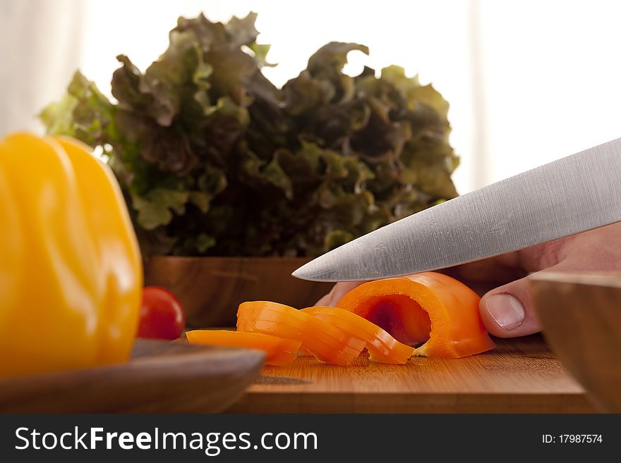 Chef Man cut vegetables on kitchen blackboard.