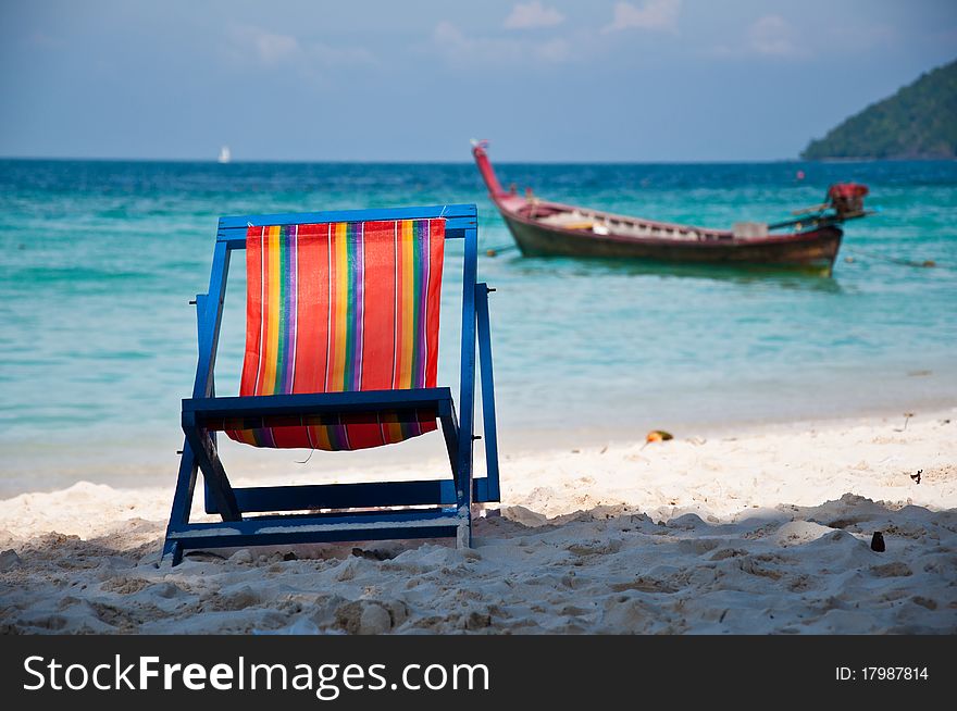 A chair and a boat on the beach. A chair and a boat on the beach