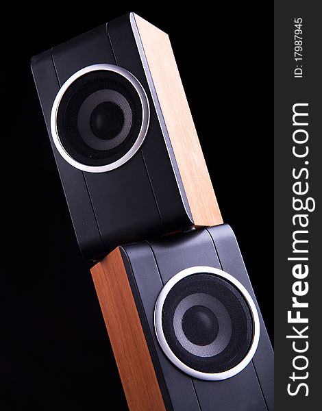 Two computer wood speakers on dark background. Two computer wood speakers on dark background