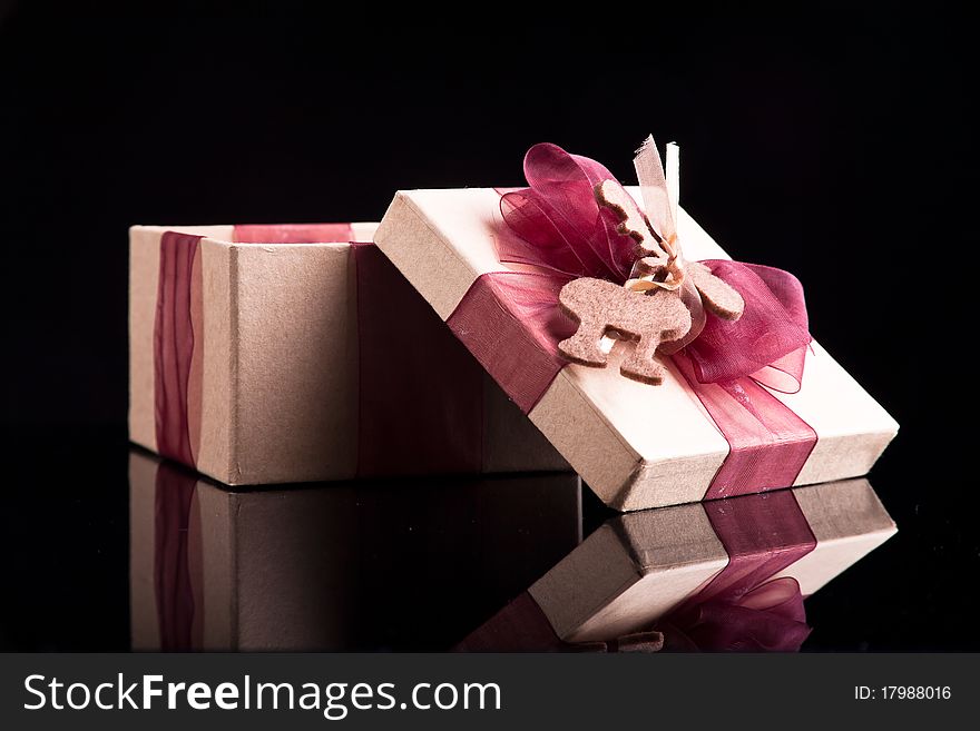 Gift box on dark background with ribbons