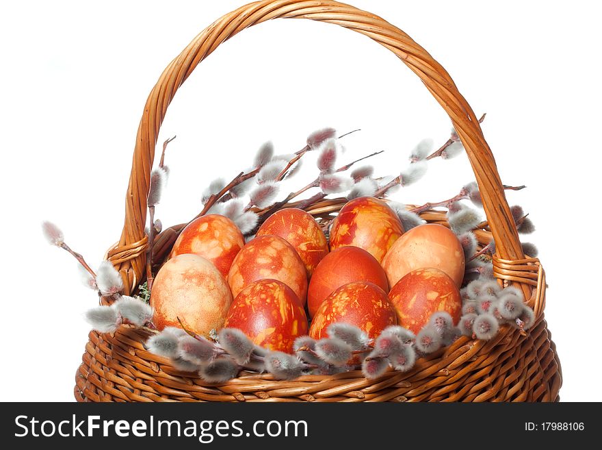 Punnet with coloured easter eggs on white isolated background