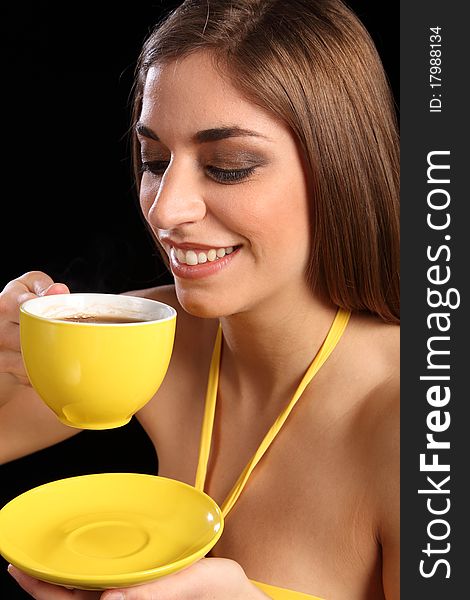 Beautiful smiling woman drinking cup of black tea