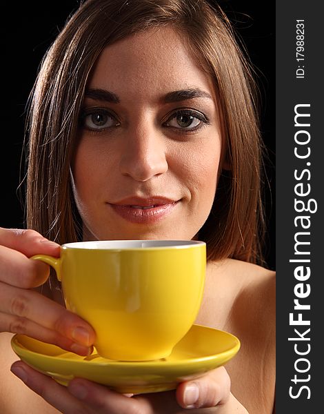 Beautiful Woman Holding Yellow Tea Cup And Saucer