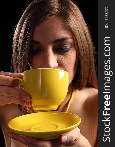 Beautiful young woman drinking cup of hot tea