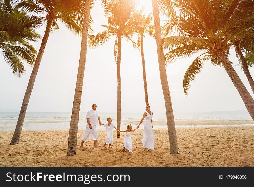 Happy young family on the sunset at the beach. Lifestyle