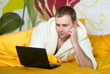 Portrait Of A Relaxed Young Guy Using Laptop Stock Photo