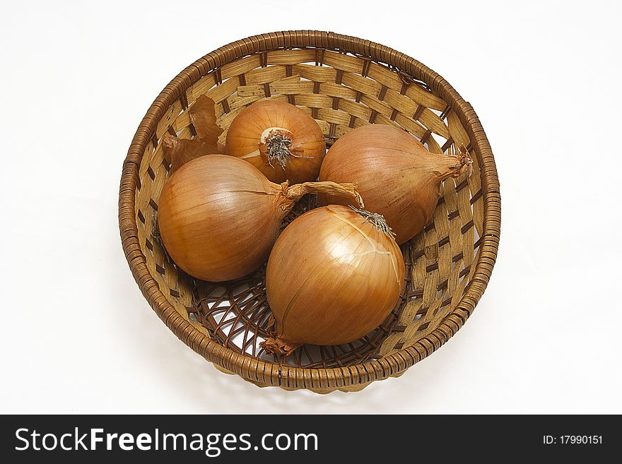 Four onion with leaves in basket