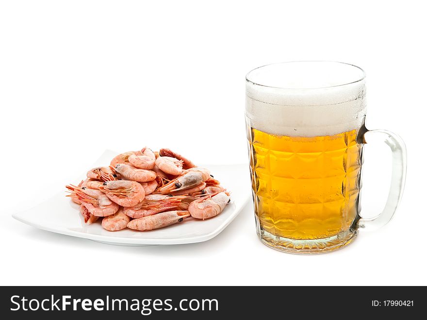 Fresh, cold beer in glass and fried shrimps on plate. Isolated on white. Fresh, cold beer in glass and fried shrimps on plate. Isolated on white