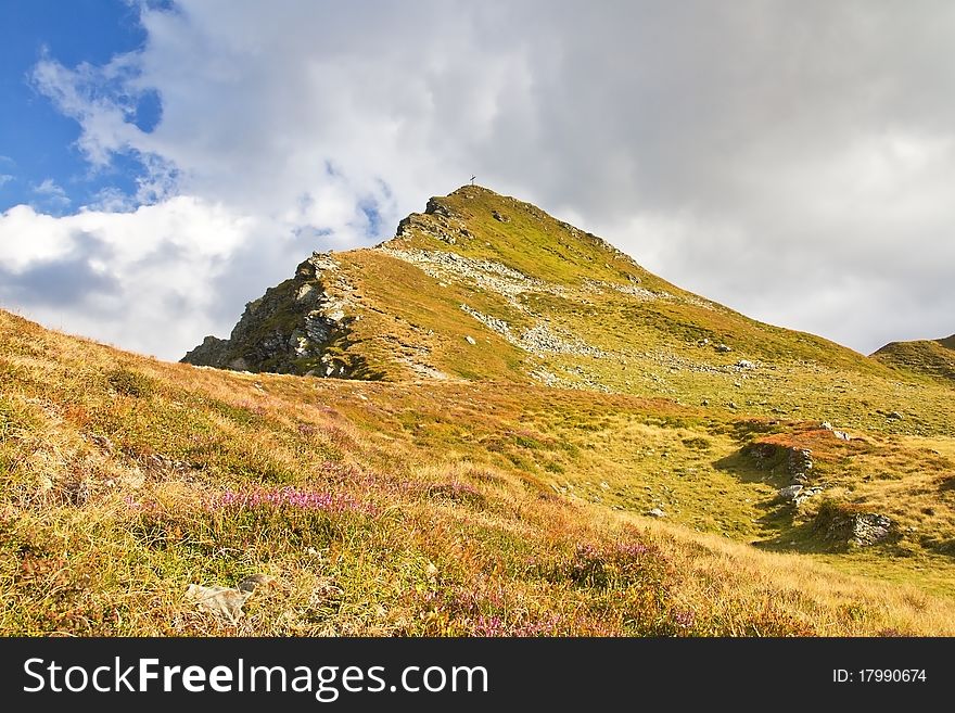 Summit Cross On A Picturesque Mountain