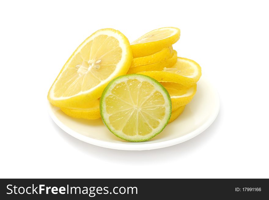 Lemon and lime slices on a plate isolated on a white background. Lemon and lime slices on a plate isolated on a white background