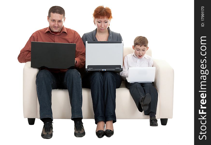 Dad mom and son with laptop sitting on the couch