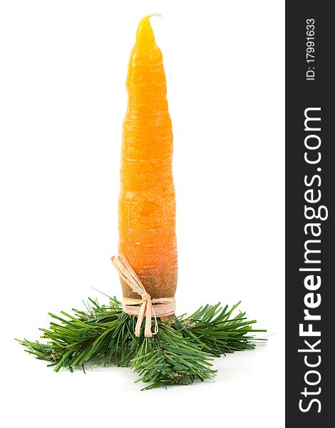 Christmas candle in the shape of a carrot on a white background