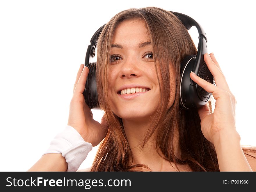 Pretty young DJ woman listening music in big headphones on mp3 player smiling and laughing isolated on white background