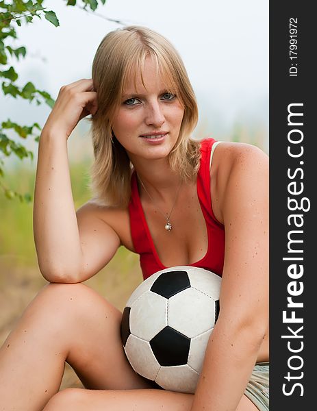 Soccer attractive girl smiling with soccer ball