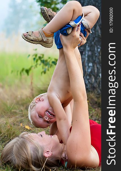 Happy mother and son in green grass