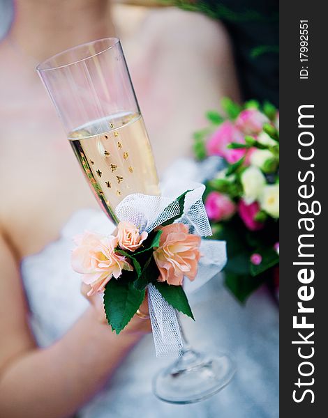 Bride with a glass and a bouquet