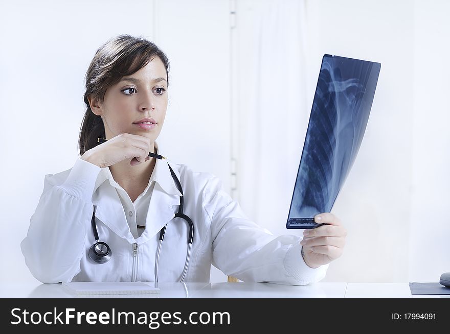 Health care on the white background; young doctor smiling and looking in camera