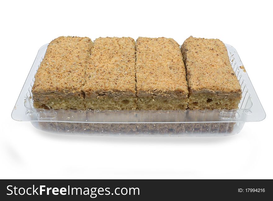 Tasty four cakes inside the plastic container isolated on the white background. Tasty four cakes inside the plastic container isolated on the white background