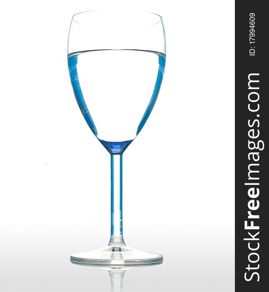 Water in a wineglasse on a wite background. Water in a wineglasse on a wite background.