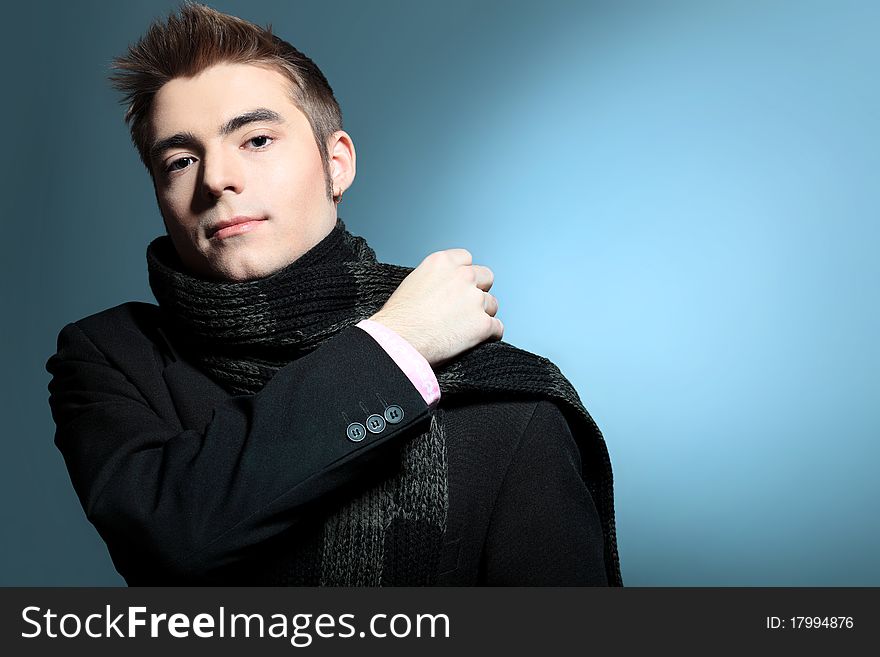 Portrait of a handsome young man posing over grey background. Portrait of a handsome young man posing over grey background.