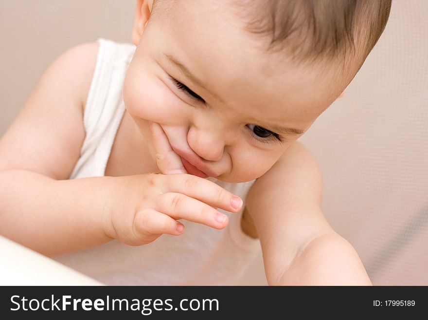 Fun caucasian baby with finger playing the ape