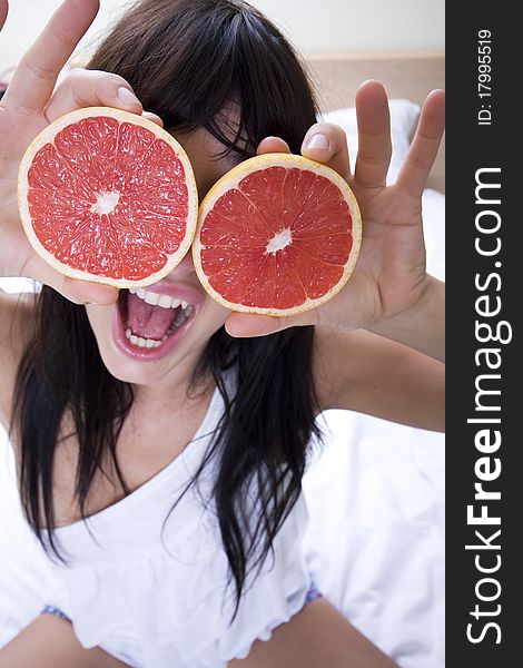Close up of young attractive woman playing with grapefruit. Close up of young attractive woman playing with grapefruit