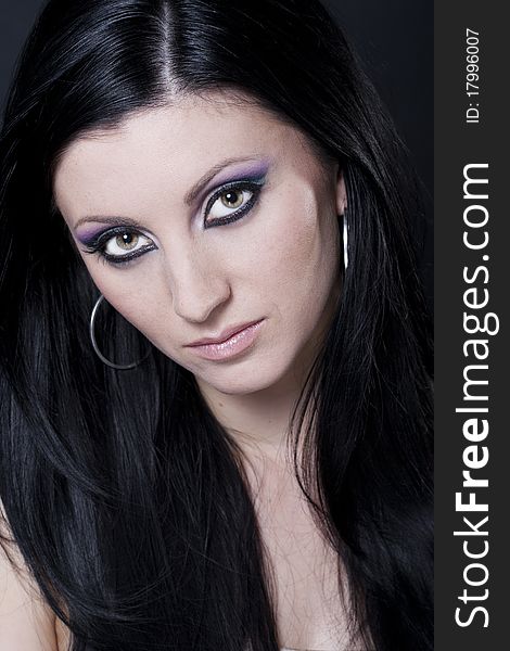 Brunette woman with blue and purple makeup