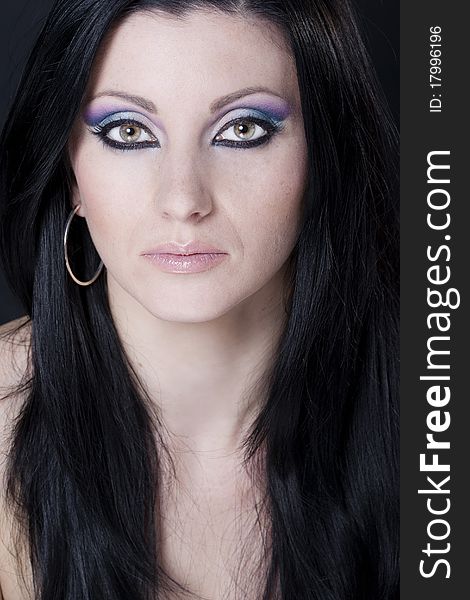 Brunette woman with blue and purple makeup