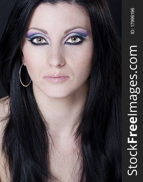 Attractive brunette woman with blue and purple makeup