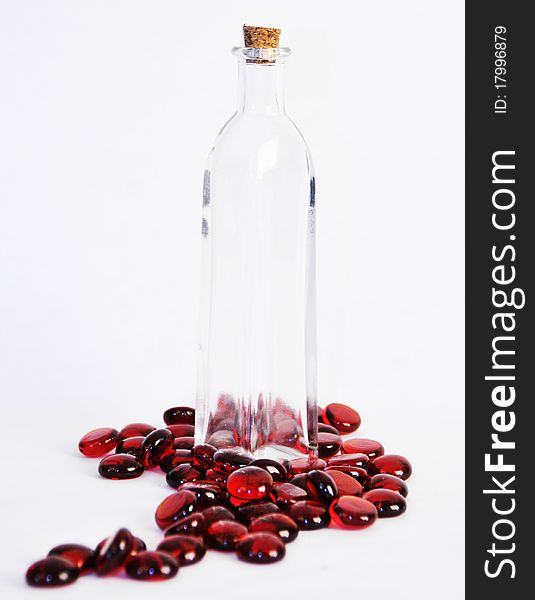 Antique glass bottle surrounded by glass beads. Antique glass bottle surrounded by glass beads