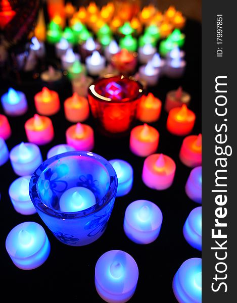 Candle with colorful defocussed lights. A perfect festive background. Candle with colorful defocussed lights. A perfect festive background.