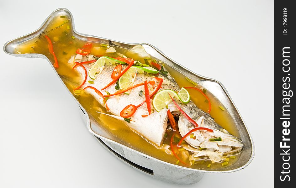 Steamed snapper fish with lemon on white background