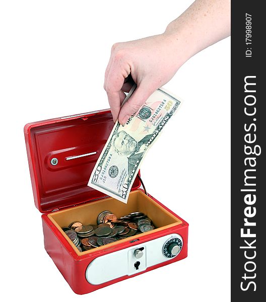 Placing a $50 bill into a safe. Placing a $50 bill into a safe
