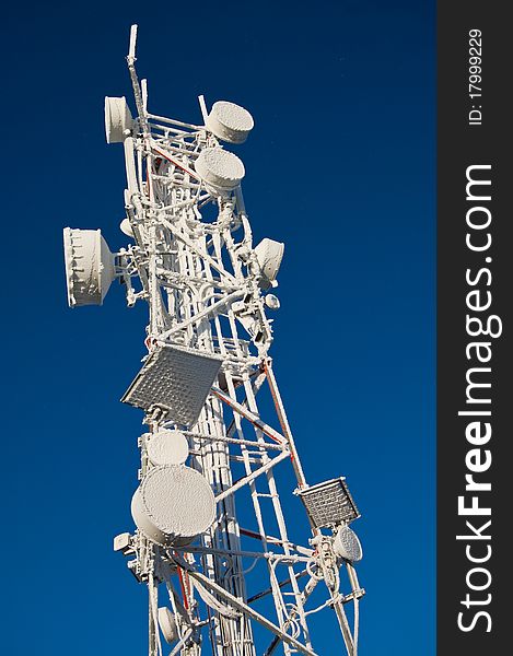 The top of a GSM antenna tower, covered in snow. The top of a GSM antenna tower, covered in snow