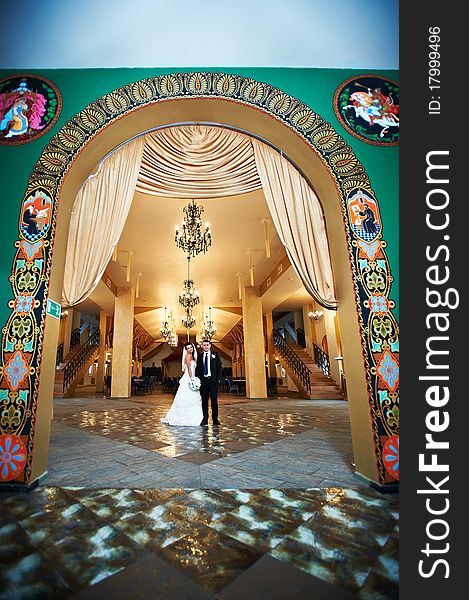 Bride and groom in beautiful interiors of Russian palace