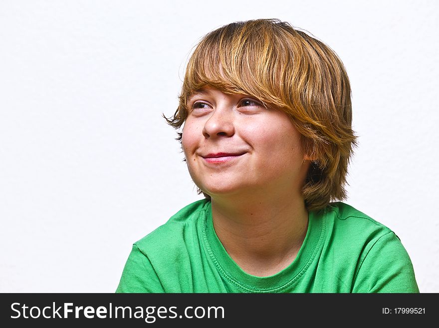 Smiling boy sitting on a sofa at home