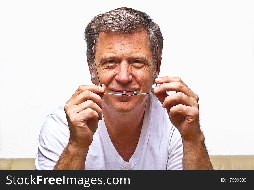 Smiling man with reading glasses