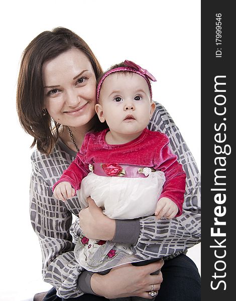 Mother with her sweet little daughter isolated on white. Mother with her sweet little daughter isolated on white.