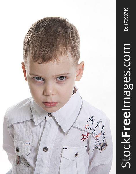 Serious boy standing on white background. Serious boy standing on white background