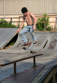 Skateboarder Landing On Rail Royalty Free Stock Image