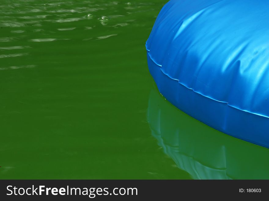 A blue float in a green pool. A blue float in a green pool.