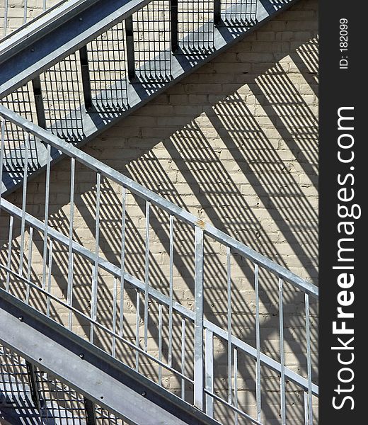 Closeup shot of a staircase and its reflection on the bricks behind. Closeup shot of a staircase and its reflection on the bricks behind.