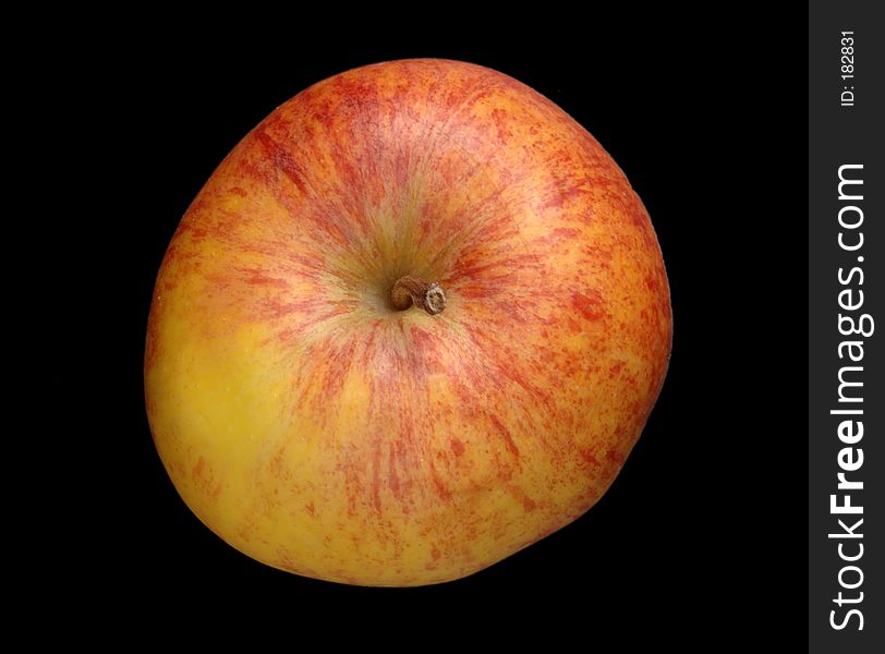 A red and yellow apple isolated over black, top down view. A red and yellow apple isolated over black, top down view.