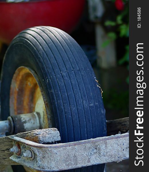 close up the wheel of an old rusty wheel barrel. close up the wheel of an old rusty wheel barrel