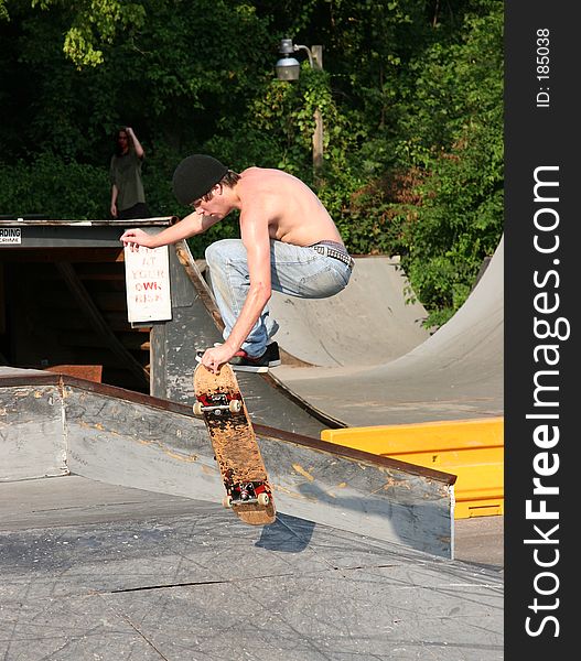 Skateboarder Grabbing Board