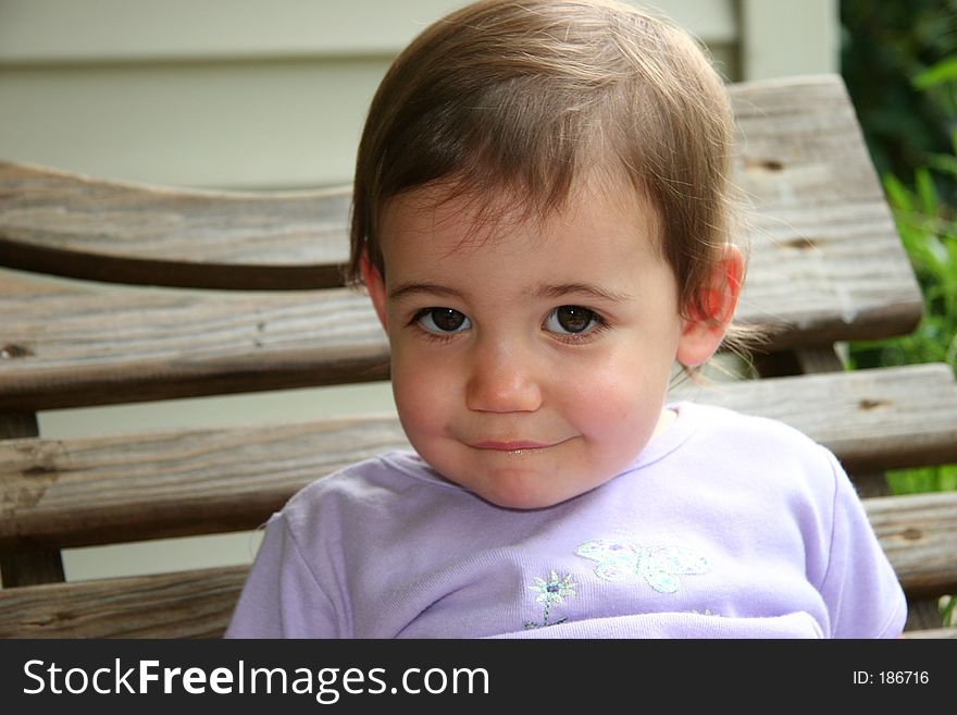 Close-up of an adorable baby girl on a swing. Shot with a Canon 20D.