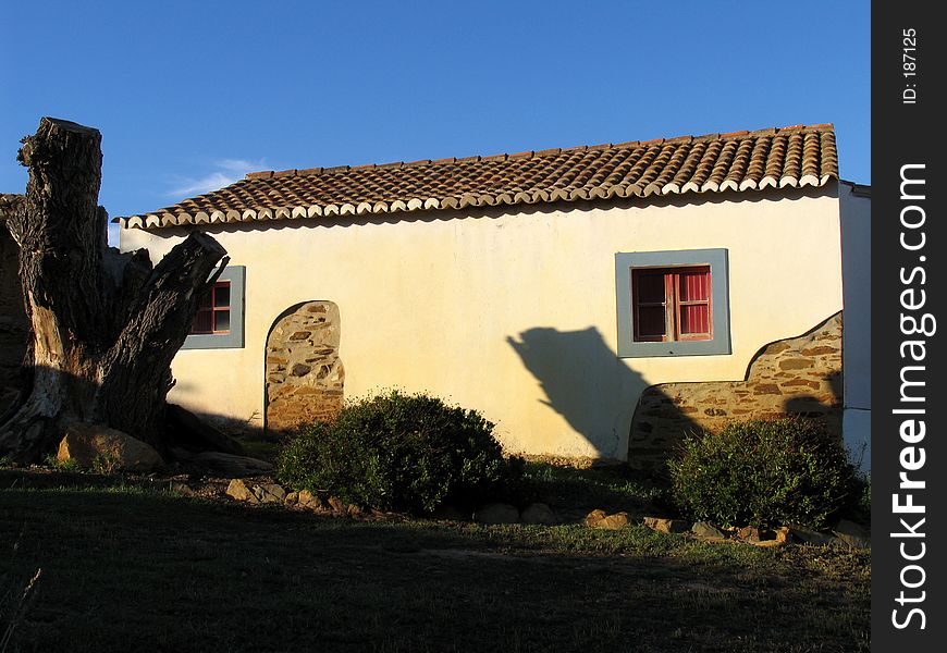 Traditional rural house of the south of Portugal. The colors are typical, with white walls (to minimize the heat of the sun) and blue frames. Traditional rural house of the south of Portugal. The colors are typical, with white walls (to minimize the heat of the sun) and blue frames