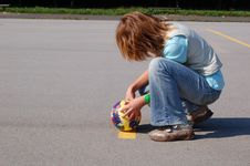 Teenage Girl Crouching On The Playgrond Stock Images