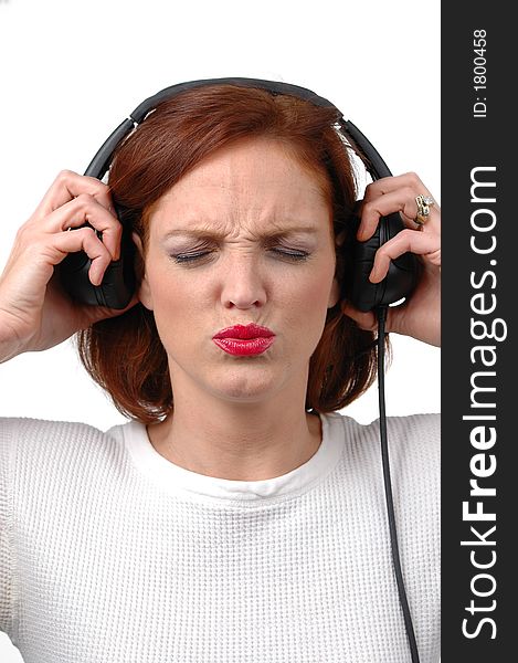 Woman with headphones listening to loud music with white background. Woman with headphones listening to loud music with white background