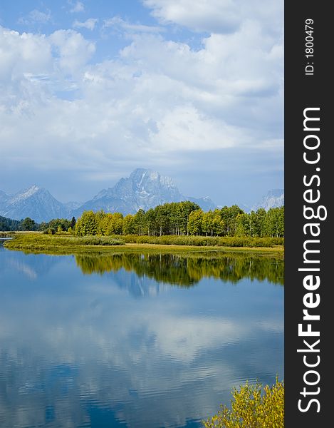 The reflection of the sky and mountains on a lake in Grand Teton National Park. The reflection of the sky and mountains on a lake in Grand Teton National Park